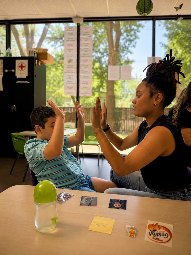 Therapist celebrating a high-five with a child
